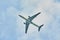 Silhouette of an airplane on sky background. Commercial airplane jetliner flying above clouds in beautiful day light. Flight trave