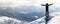 Silhouette of alone tourist standing on snowy mountain top in wi