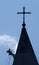 Silhouette of the alpinist cleans church roof