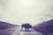 Silhouette of American bison crossing road.