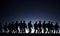 a silhouette of american soldiers marching in formation, with the full moon in the foreground