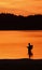 Silhouette of the angler in the lake