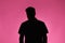 Silhouette of anonymous man on pink