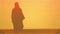 Silhouette of an arab woman lonely standing in the desert.