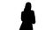Silhouette Arabic Business woman wearing hijab speaking on the p