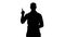 Silhouette Arabic man in casual making attention gesture finger up.