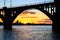 Silhouette of an arched railway bridge on a beautiful sunset on the Dnieper River in the city of Dnipropetrovsk
