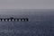 Silhouette of Ardrossan jetty on a bright day, mid morning.