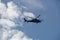 Silhouette army helicopter hovering on a beautiful sky background.