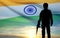 Silhouette of army soldier with India flag on a background the sunset or the sunrise