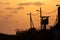 Silhouette of army watchtower behind barbed wires