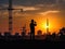 Silhouette of asian engineer and worker inspecting project at construction site background