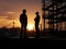 Silhouette of asian engineer and worker inspecting project at construction site background