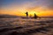 Silhouette asian fisherman on wooden boat