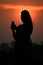 Silhouette asian woman touching smartphone at Sunset time