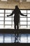 Silhouette Athlete man jumping rope in the gym in front of large panoramic windows