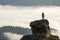 Silhouette of athletic climber tourist on high rocky formation o