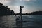 silhouette of athletic woman standup paddleboarding