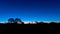 Silhouette of Australian Outback in front against a late sunset sky