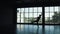 Silhouette of a ballet dancer male against the background of a large window. the dancer makes a high jump. slow motion