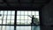Silhouette of a ballet dancer male against the background of a large window. slow motion