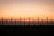 Silhouette barbed wire fence