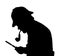 Silhouette of bearded man investigating with a magnifying glass