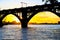 Silhouette of a beautiful arched railway bridge and wagons on the Dnieper river at sunset. Dnipropetrovsk