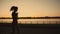 Silhouette of a beautiful asian girl run along the river. Taste of freedom. Playing sports at sunrise or sunset. Solo