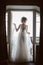 Silhouette of beautiful bride in traditional white wedding dress