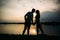 Silhouette of beautiful couple. lake in background