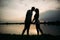 Silhouette of beautiful couple. lake in background