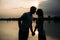 Silhouette of beautiful couple. lake in background