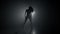 Silhouette of beautiful dancer on smoky dark background.Spotlight shines back