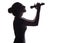 Silhouette of beautiful girl singing into microphone, profile of young woman face performing lyric song on white isolated