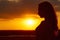 Silhouette of a beautiful romantic girl at sunset , face profile of young woman with long hair in hot weather