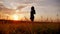 Silhouette of a beautiful teen girl standing on a background of gorgeous sunsets