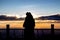 silhouette of a beautiful woman standing on panoramic viewpoint.