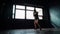 Silhouette beautiful young boxing woman training punching in fitness studio