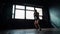 Silhouette beautiful young boxing woman training punching in fitness studio