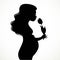 Silhouette of a beautiful young pregnant woman with lush hair sniffs a tulip flower