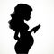 Silhouette of beautiful young pregnant woman uses an mobile phone