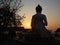 Silhouette of behind Buddha on sunset