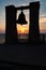 Silhouette of a bell on a background of the sea and sunset, Crimea, Chersonese