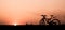 Silhouette a bicycle with beautiful twilight sky background on the roadside