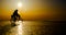 Silhouette of bicyclist on the ice of frozen lake