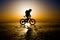 Silhouette of bicyclist riding on the clear ice