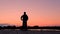 Silhouette of a bicyclist. The teenager rides a bicycle along the embankment. Sports lifestyle.