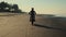 Silhouette of a biker on the tropical coastline at dusk