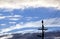 Silhouette of Bird on Electricity Pole with Wintry Clouds